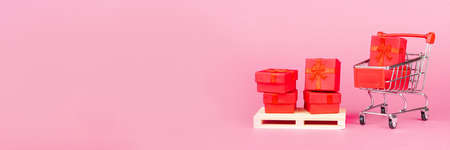 Paper art Valentine's day concept banner with handmade gift box, cut ribbon, bow with space for text. Christmas giftの写真素材