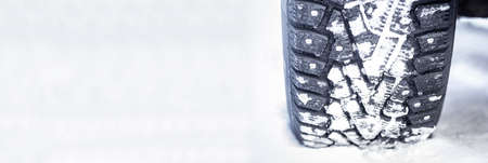 winter tires with spikes on snow, transport road northern wheels, climate winter seasonの写真素材