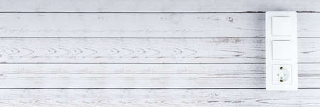 Plug Into Electricity Socket the power outlets on the wooden wallの写真素材