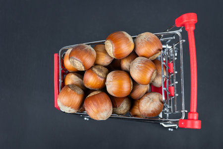 Nutritious hazelnuts in a basket and scattered on the ground. Hazelnuts in a shopping basket....