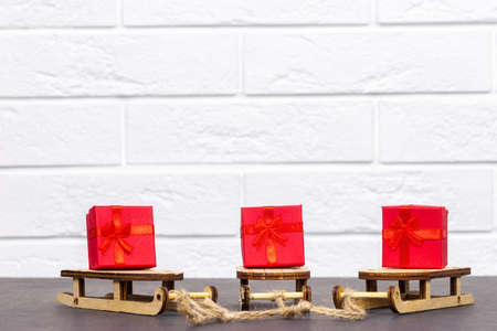 red Christmas gift box decorated on a sleigh, Christmas giftの写真素材