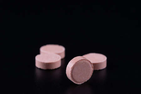 vitamins, tablets and pills lie on a black background. medicines are on the table. pills on a black background.の写真素材
