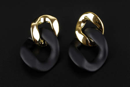 Diamond jewelry earrings, luxury silver and gold earrings with diamonds, sapphires in black background.の写真素材