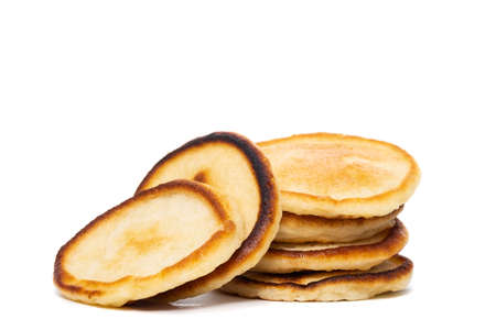 A stack of plain pancakes on a white background.の写真素材