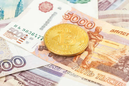 Bitcoin coins (new virtual money) on Russian banknotes A close up image of bitcoins with Russian rubles banknotes Bitcoin coin on the background of Russian rubles Bitcoin Russia Ruble Cryptocurrencyの写真素材