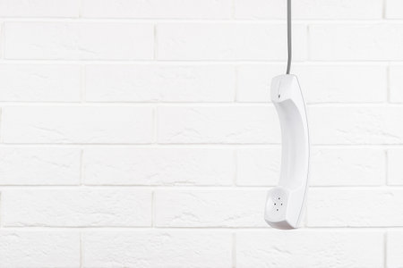 White phone handset with soft shadow on whiteの写真素材