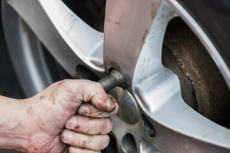 Car wheel replacement. Self-service tire fitting concept. Installing a new wheel. Winter and summer...