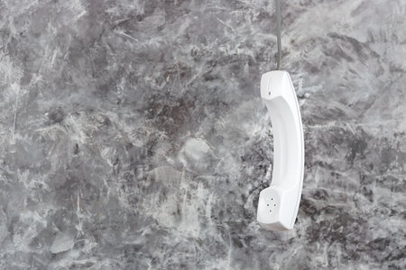 White phone handset with soft shadow on grayの写真素材