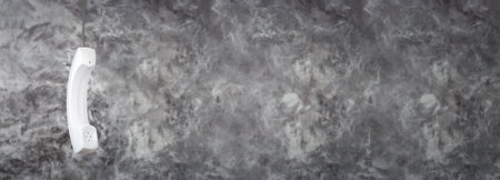 White phone handset with soft shadow on grayの写真素材
