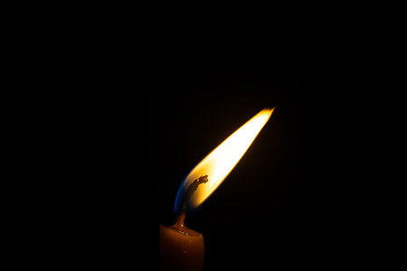 Candle flame close up on a black backgroundの写真素材