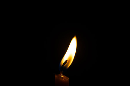 Candle flame close up on a black backgroundの写真素材