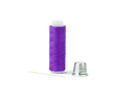 Spool sewing thread with needle and thimble on white backgroundの写真素材