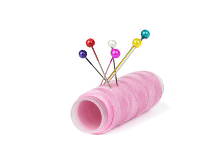 Spool sewing thread with needle and thimble on white backgroundの写真素材