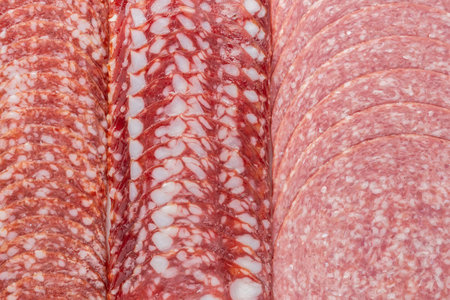 Smoked sausage slice with fat closeup background