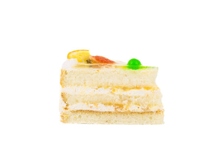Layered cheesecake piece with orange and berries isolated on white background.の写真素材