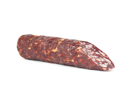 A piece of dry salami sausage, highlighted on a white backgroundの写真素材