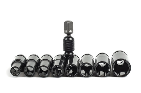 A ratchet and a set of interchangeable heads for a chrome-plated socket wrench. Isolated on a white backgroundの写真素材