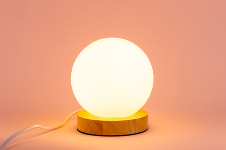 A glowing lamp on a pink background