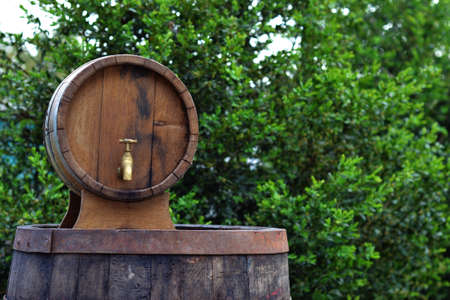 background of barrel and worn old table of woodの写真素材