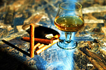 Beautiful background of a table with wood on it cigars, cognac.の写真素材