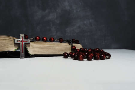 Bible and the crucifix on a gold table. Beautiful new wood background. Religion concept