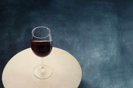 Glass of red wine on white table. Beautiful dark backgroundの写真素材
