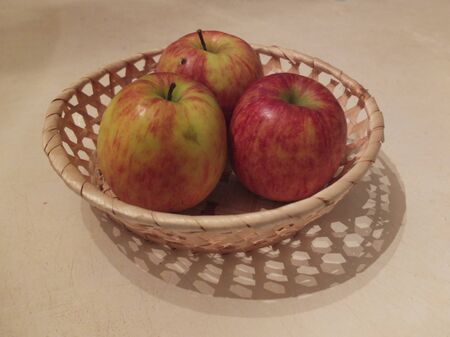 Sweet apples in a wicker basket.の写真素材