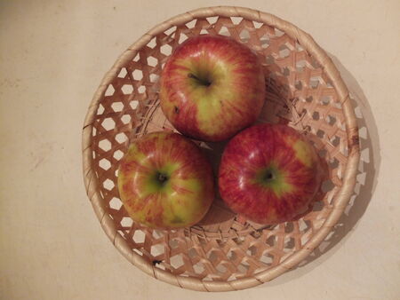 Sweet apples in a wicker basket.の写真素材