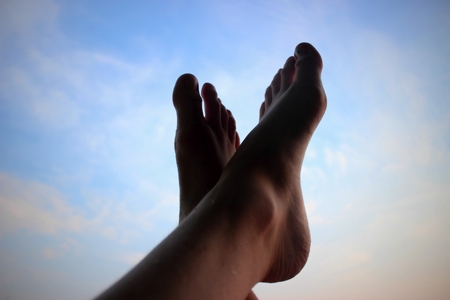 Relaxing legs in the summer sky.の写真素材