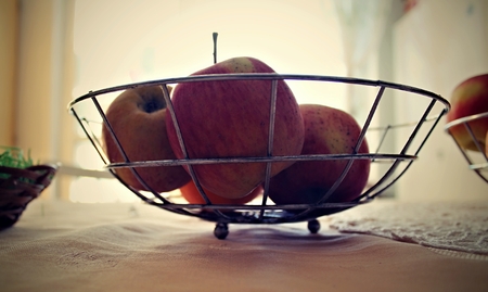 Fresh apples in a basket on the table.の写真素材