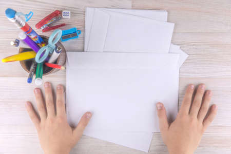 child prepared envelopes for letters to Santa Claus, a wooden tableの写真素材