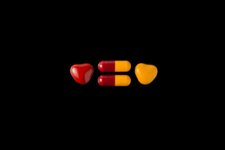 danger of poisoning children with drugs: a few tablets next to the caramel of the same colorの写真素材