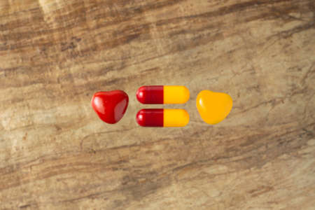 danger of poisoning children with drugs: a few tablets next to the caramel of the same colorの写真素材