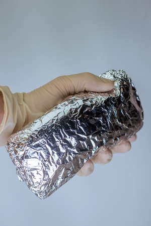medical officer of the laboratory holds in his hand confiscated by the police a package of powder of narcotic substance, for the analysisの写真素材