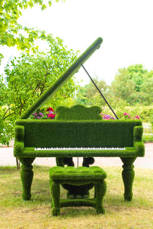 green floral piano with a variety of flowers inside, in the spring gardenの写真素材