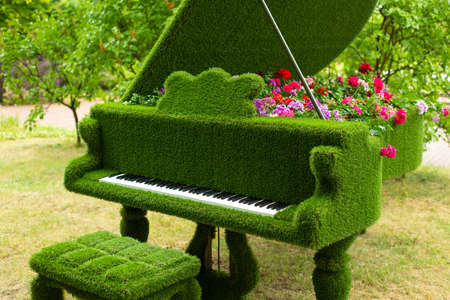 green floral piano with a variety of flowers inside, in the spring gardenの写真素材