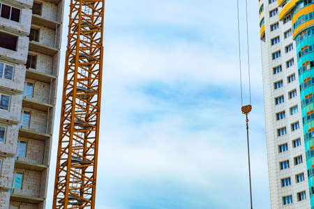construction of multi-storey buildings: a crane and high-rise houseの写真素材