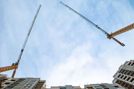 construction of multi-storey buildings: a crane and high-rise houseの写真素材