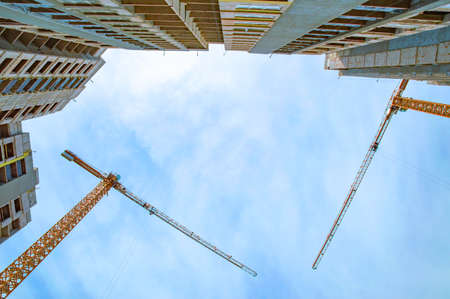 construction of multi-storey buildings: a crane and high-rise houseの写真素材
