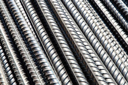 bright iron grunge background: glittering new clean reinforcement bars, short focusの写真素材