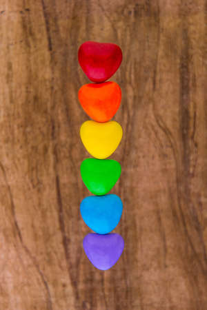 struggle for happiness and equality of sexual minorities: 6 multi-colored candy with the iridescent color of the LGBT flag, short focus, woody backgroundの写真素材