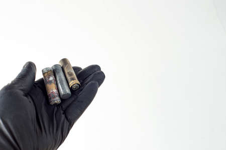 deadly environmental pollution from hazardous waste industry concept: mercury and cadmium old batteries in handの写真素材