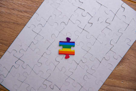 Place of LGBT people in the public structure: puzzle with the coloring of the rainbow flag against a...