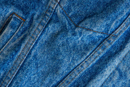 classic grunge background: real old american denim, close, scar and thread, short focus, top view