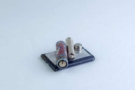 mercury and cadmium pollution of the planet: a few spent batteries are isolated on white, short...