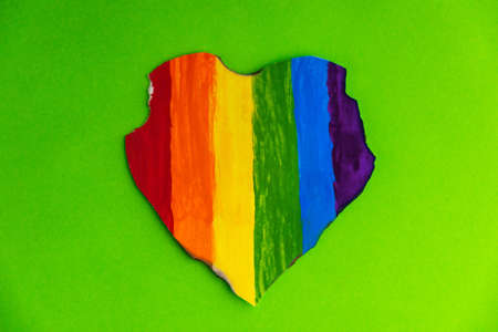 Concept - harassment of the freedom of the LGBT community: a burned and torn rainbow heart, short focusの写真素材