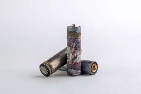 recycling of household batteries: several batteries are isolated on white, short focus, toningの写真素材