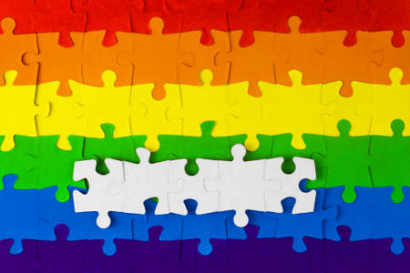 equality advocacy: a mosaic of LGBT flag colors with a few white puzzles with free space