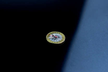 time and money, concept: second, hour and minute hands on a coin of 2 Belarusian rubles, against a dark backgroundの写真素材