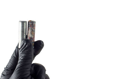 deadly environmental pollution from hazardous waste industry concept: mercury and cadmium old batteries in handの写真素材